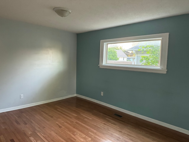 663 Smith Ave S, Saint Paul, MN 55107 - empty room with wood finished floors and baseboards