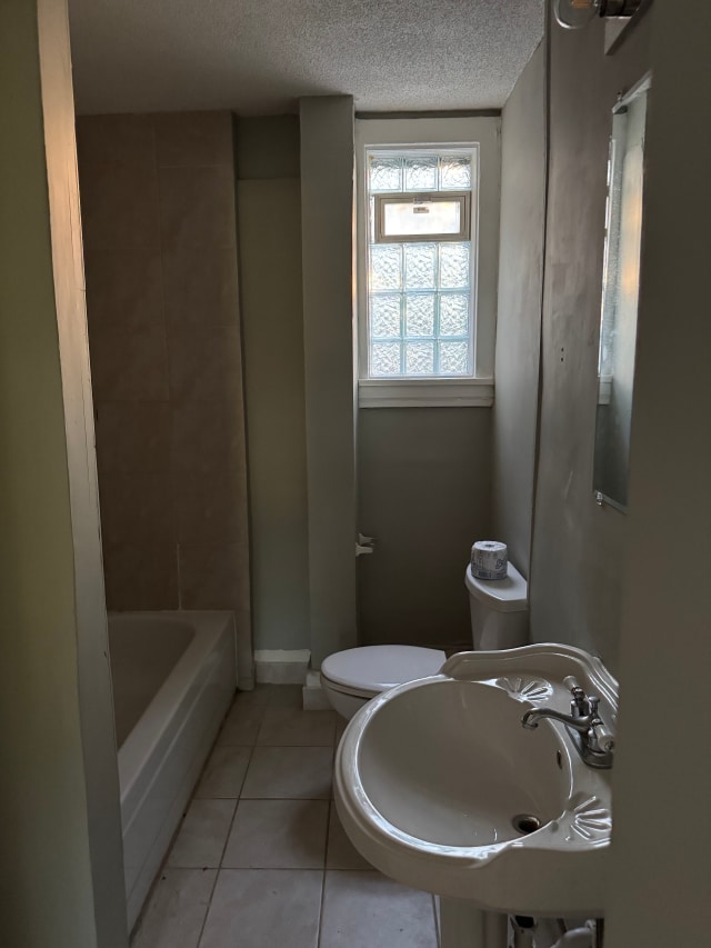 663 Smith Ave S, Saint Paul, MN 55107 - bathroom with a textured ceiling and tile patterned floors