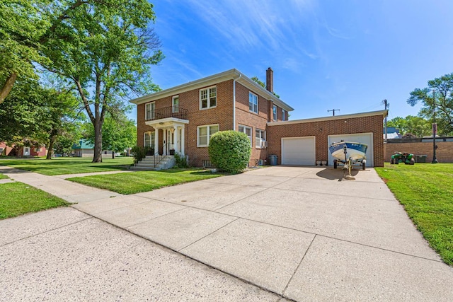 440 6th St, Lafayette, MN 56054 - view of front facade with brick siding, a chimney, concrete driveway, and a front yard