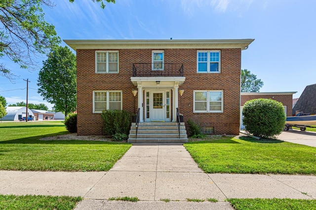 440 6th St, Lafayette, MN 56054 - colonial home with brick siding and a front lawn