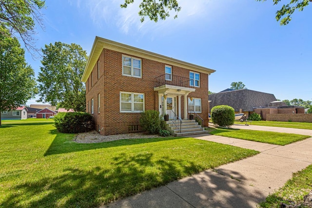 440 6th St, Lafayette, MN 56054 - view of front facade featuring brick siding and a front lawn
