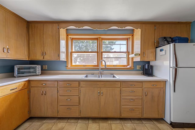 440 6th St, Lafayette, MN 56054 - kitchen with freestanding refrigerator, light countertops, and brown cabinets