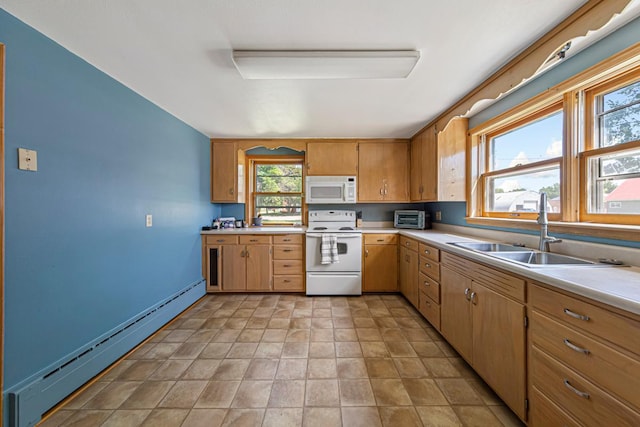 440 6th St, Lafayette, MN 56054 - kitchen with white appliances, a baseboard radiator, light countertops, and light stone finish flooring
