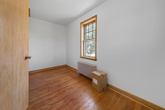 440 6th St, Lafayette, MN 56054 - spare room featuring radiator and hardwood / wood-style floors