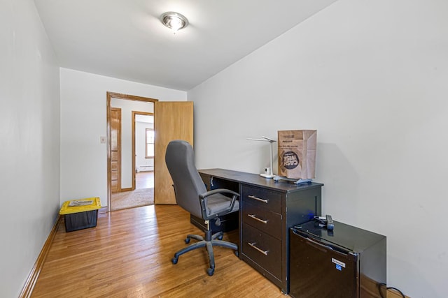440 6th St, Lafayette, MN 56054 - office area featuring light wood-style floors and a baseboard heating unit