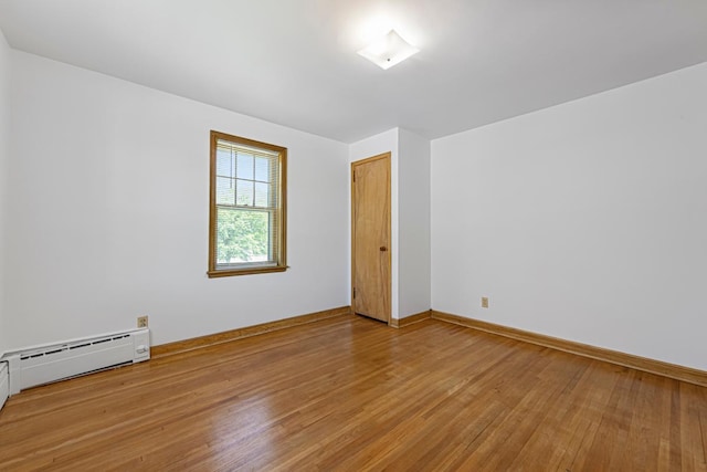440 6th St, Lafayette, MN 56054 - empty room with light wood finished floors and a baseboard heating unit