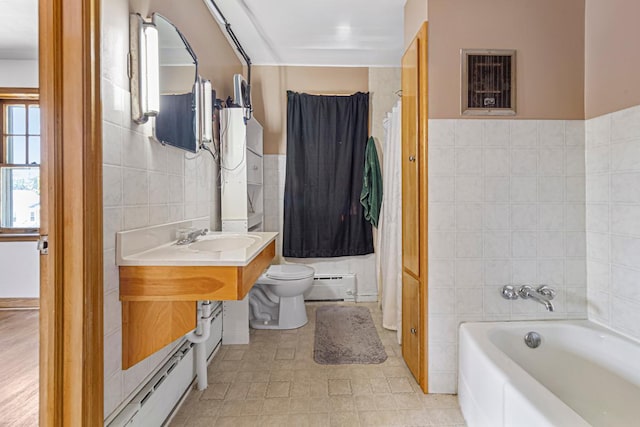 440 6th St, Lafayette, MN 56054 - bathroom with tile walls, baseboard heating, and vanity