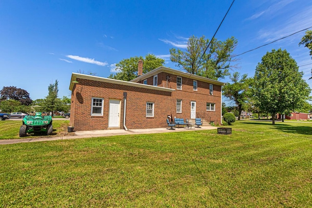 440 6th St, Lafayette, MN 56054 - rear view of property featuring a patio, a lawn, a chimney, and brick siding