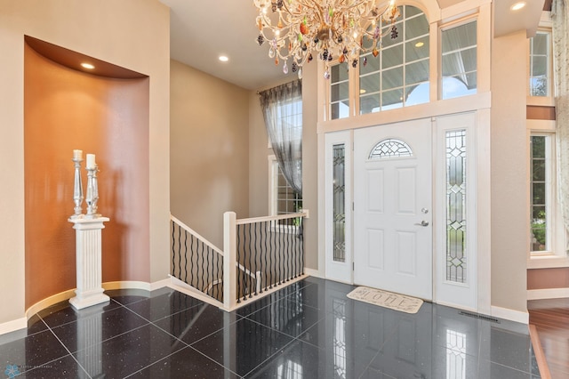 1811 7th St, Fargo, ND 58078 - foyer with a chandelier, healthy amount of natural light, granite floors, a towering ceiling, and recessed lighting