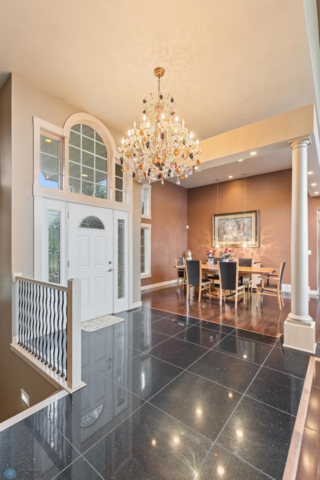 1811 7th St, Fargo, ND 58078 - foyer entrance featuring granite floors, a chandelier, decorative columns, and recessed lighting