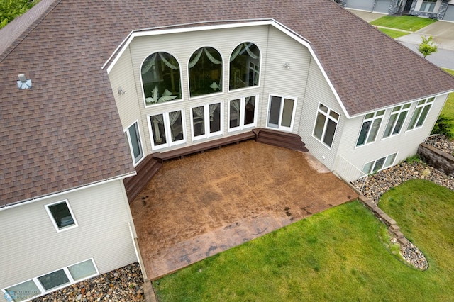 1811 7th St, Fargo, ND 58078 - rear view of house with a shingled roof and a yard