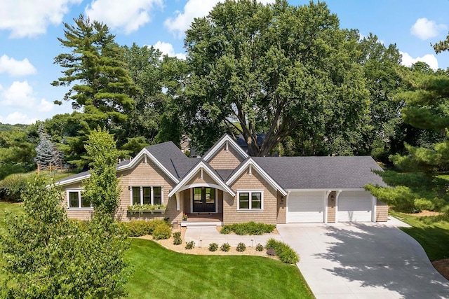 5815 Howards Point Rd, Shorewood, MN 55331 - craftsman house featuring driveway, an attached garage, and a front lawn