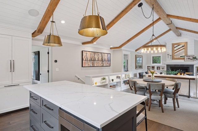 5815 Howards Point Rd, Shorewood, MN 55331 - kitchen featuring open floor plan, dark wood-style flooring, gray cabinets, a lit fireplace, and light stone countertops