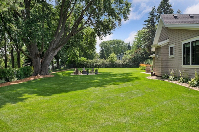 5815 Howards Point Rd, Shorewood, MN 55331 - view of grassy yard with a fire pit