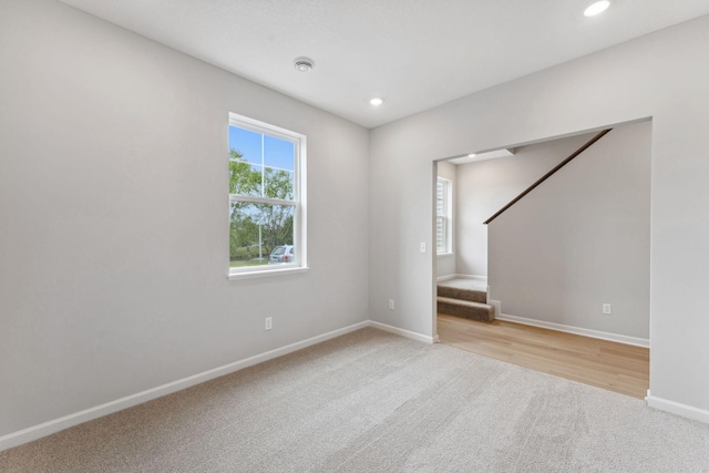 7407 E Ramsey Pkwy NW, Ramsey, MN 55303 - empty room with light carpet, stairway, and recessed lighting