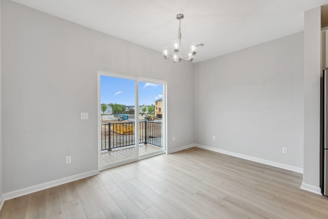 7407 E Ramsey Pkwy NW, Ramsey, MN 55303 - spare room featuring a chandelier and light wood-style floors
