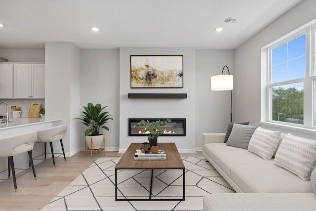 7407 E Ramsey Pkwy NW, Ramsey, MN 55303 - living area featuring recessed lighting, light wood finished floors, and a glass covered fireplace