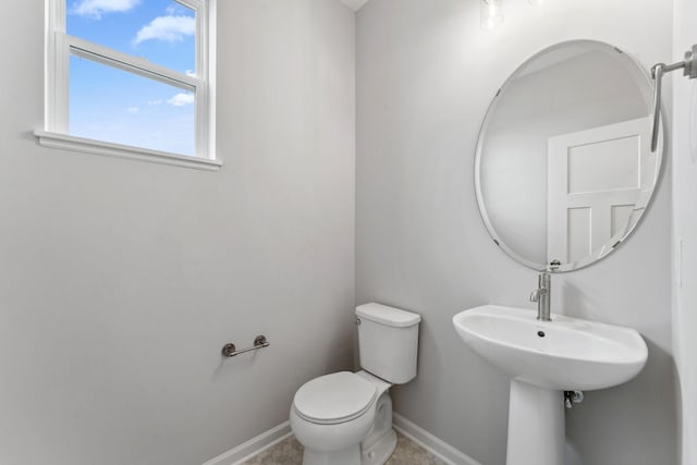 7407 E Ramsey Pkwy NW, Ramsey, MN 55303 - half bathroom featuring baseboards and toilet