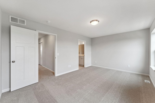 7407 E Ramsey Pkwy NW, Ramsey, MN 55303 - unfurnished bedroom featuring light colored carpet and ensuite bathroom