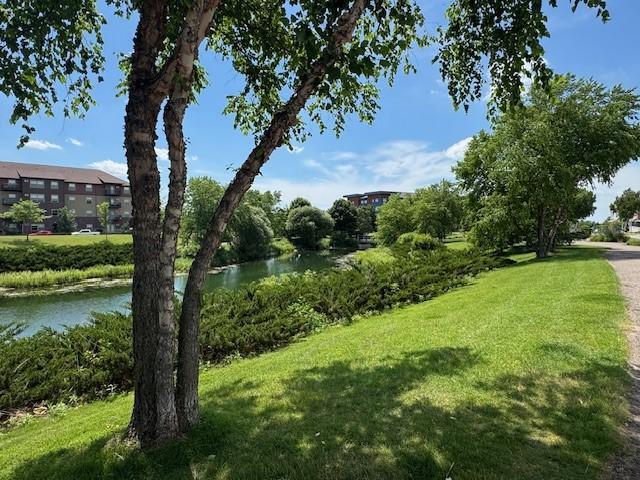 7407 E Ramsey Pkwy NW, Ramsey, MN 55303 - view of grassy yard with a water view
