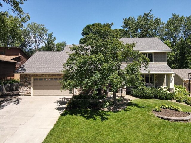 461 Dudley Ave, Shoreview, MN 55126 - view of front of home with concrete driveway, roof with shingles, a garage, and a front lawn