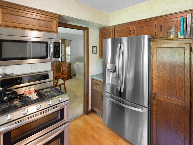 461 Dudley Ave, Shoreview, MN 55126 - kitchen featuring appliances with stainless steel finishes, brown cabinets, and light wood finished floors