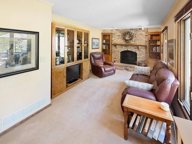 461 Dudley Ave, Shoreview, MN 55126 - living area with carpet, ornamental molding, a brick fireplace, and built in shelves