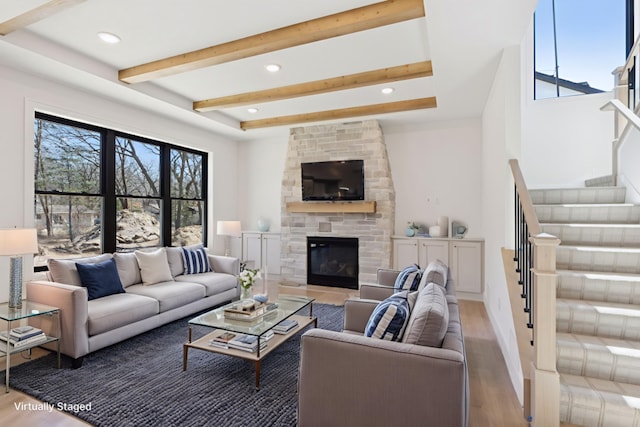 987 Island Lake Ave, Shoreview, MN 55126 - living room featuring wood finished floors, plenty of natural light, stairway, beam ceiling, and a fireplace