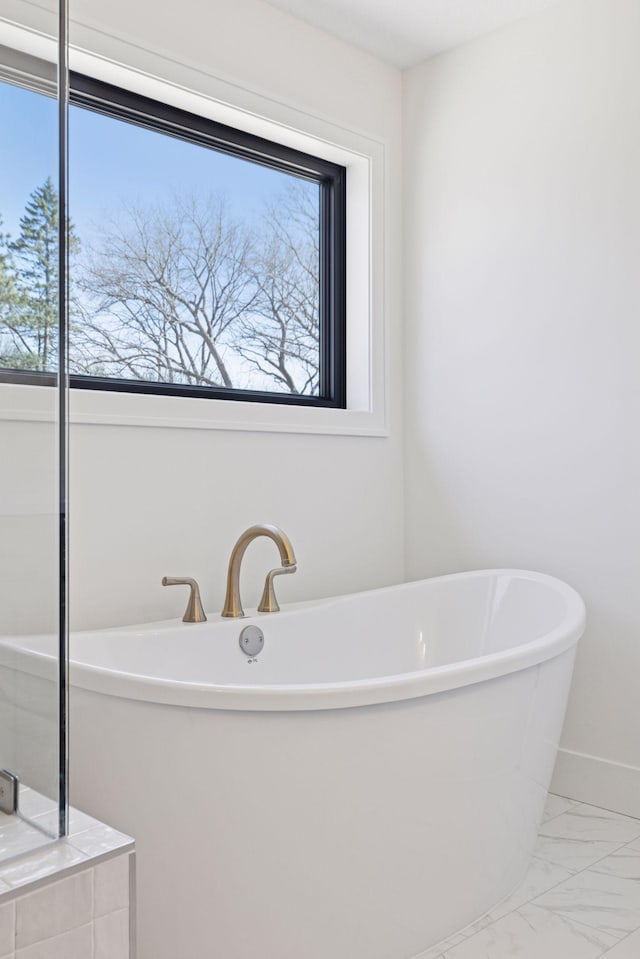 987 Island Lake Ave, Shoreview, MN 55126 - bathroom with marble look tile flooring and a freestanding bath