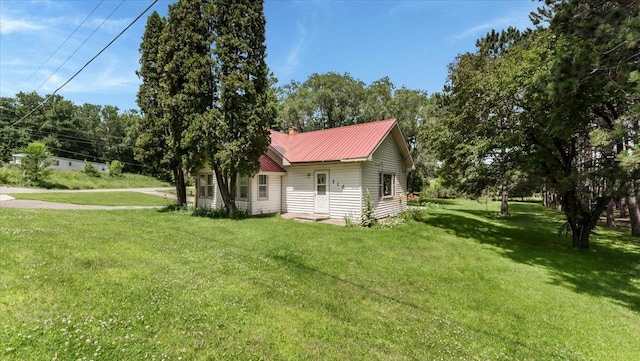114 Fairview Ave NW, Long Prairie, MN 56347 - view of property exterior featuring a yard and a metal roof