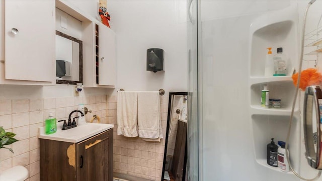 114 Fairview Ave NW, Long Prairie, MN 56347 - full bath with vanity, tile walls, and a shower