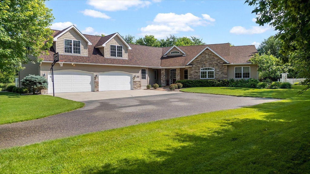 15799 109th St NW, Southside Twp, MN 55382 - view of front of house with stone siding, concrete driveway, a front yard, and roof with shingles