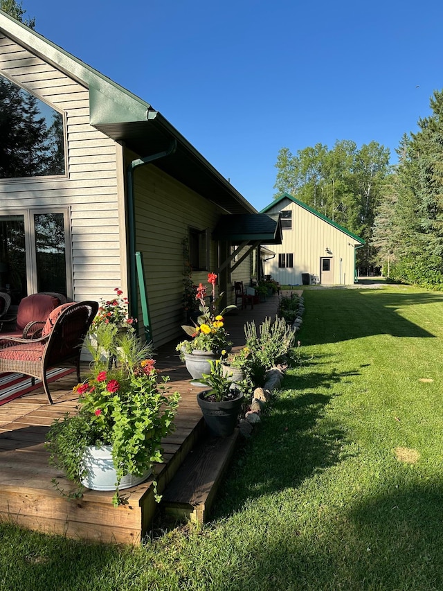 1415 Riverside Dr NW Unit 1415, Baudette, MN 56623 - view of grassy yard with a deck