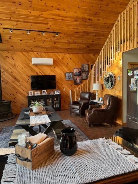 1415 Riverside Dr NW Unit 1415, Baudette, MN 56623 - living room featuring wood finished floors, wooden walls, and a wood stove