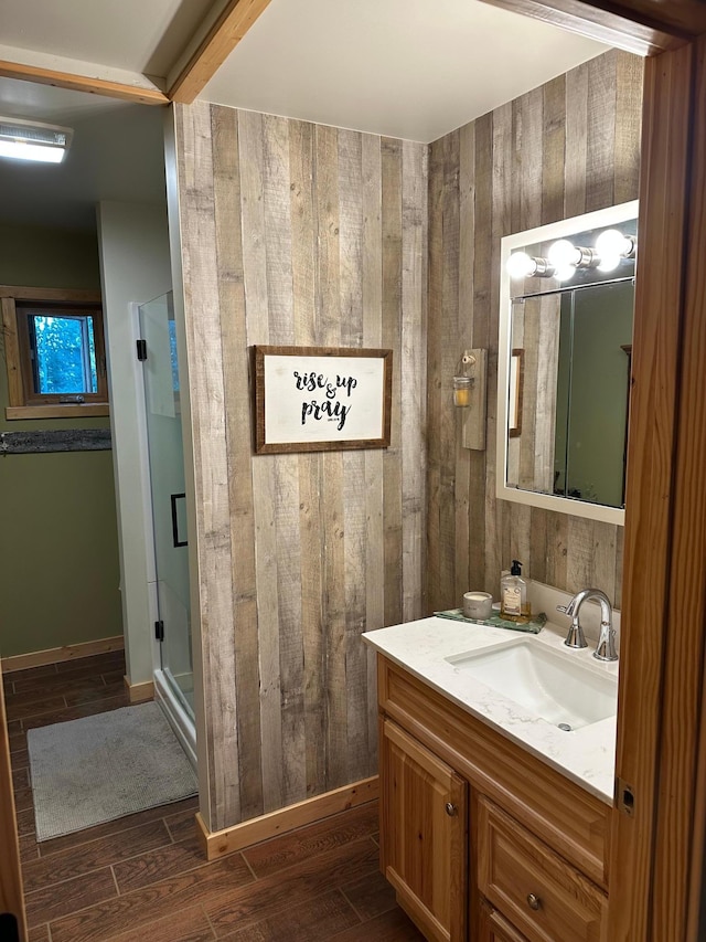 1415 Riverside Dr NW Unit 1415, Baudette, MN 56623 - full bathroom featuring wooden walls, vanity, a shower stall, and wood finished floors