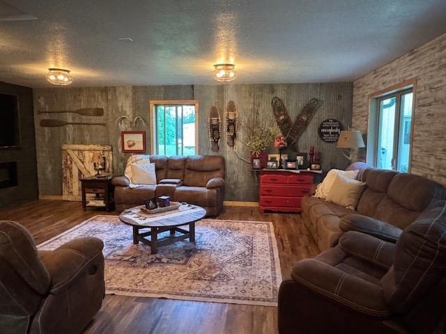 1415 Riverside Dr NW Unit 1415, Baudette, MN 56623 - living room with wood finished floors, a textured ceiling, and a fireplace