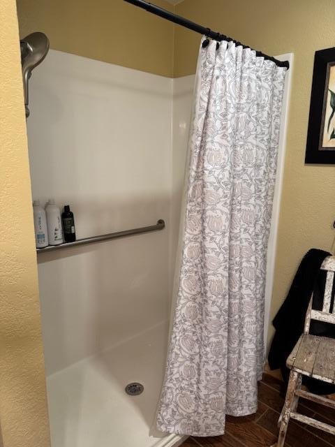 1415 Riverside Dr NW Unit 1415, Baudette, MN 56623 - bathroom with a shower with curtain and wood finished floors