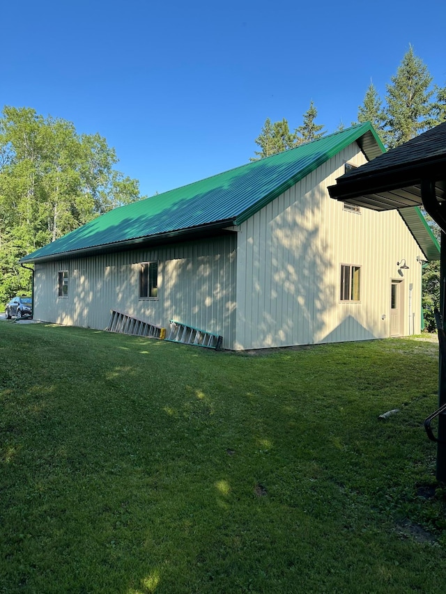 1415 Riverside Dr NW Unit 1415, Baudette, MN 56623 - view of property exterior with a yard, a metal roof, and an outdoor structure