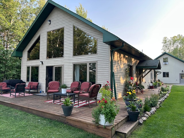 1415 Riverside Dr NW Unit 1415, Baudette, MN 56623 - back of property featuring a deck, a lawn, and outdoor lounge area