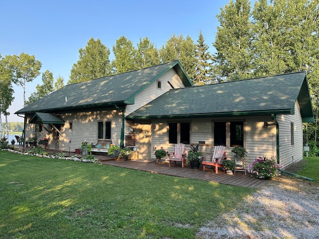 1415 Riverside Dr NW Unit 1415, Baudette, MN 56623 - view of front of home featuring a front lawn, roof with shingles, and a wooden deck