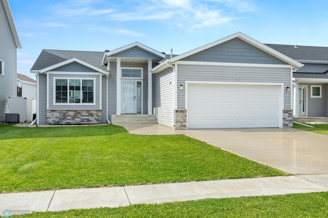 6028 59th Ave S, Fargo, ND 58104 - view of front facade with stone siding, concrete driveway, an attached garage, and a front lawn