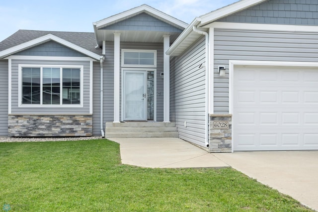 6028 59th Ave S, Fargo, ND 58104 - view of front of house featuring stone siding, a garage, and a front yard