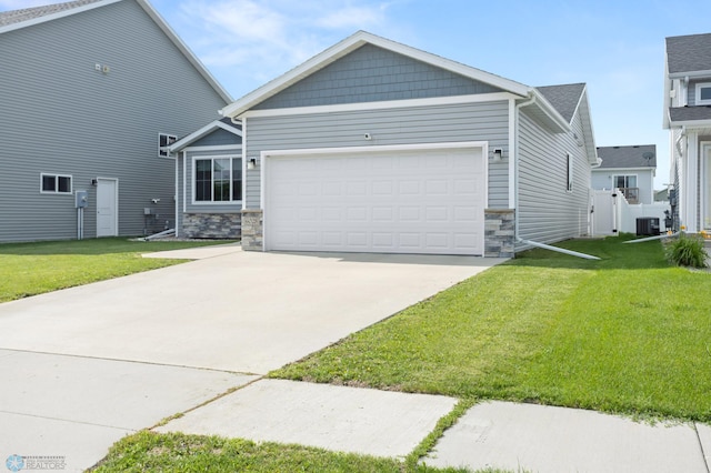 6028 59th Ave S, Fargo, ND 58104 - craftsman-style house with stone siding, an attached garage, a front lawn, and concrete driveway