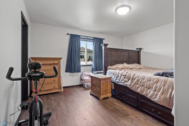 6028 59th Ave S, Fargo, ND 58104 - bedroom with dark wood-style flooring and baseboards