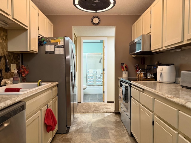 120 Demont Ave E Unit 208, Little Canada, MN 55117 - kitchen with stainless steel appliances, light countertops, white cabinetry, and a textured ceiling