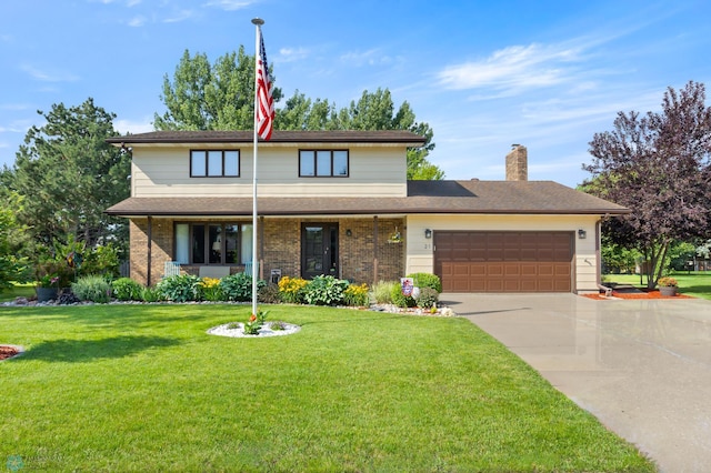 21 35th Ave NE, Fargo, ND 58102 - view of front facade with driveway, an attached garage, a front lawn, a chimney, and brick siding
