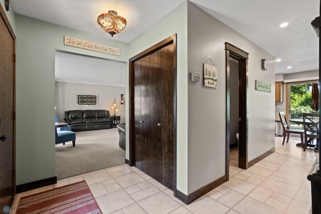 21 35th Ave NE, Fargo, ND 58102 - hall featuring a textured ceiling, light carpet, recessed lighting, and light tile patterned floors