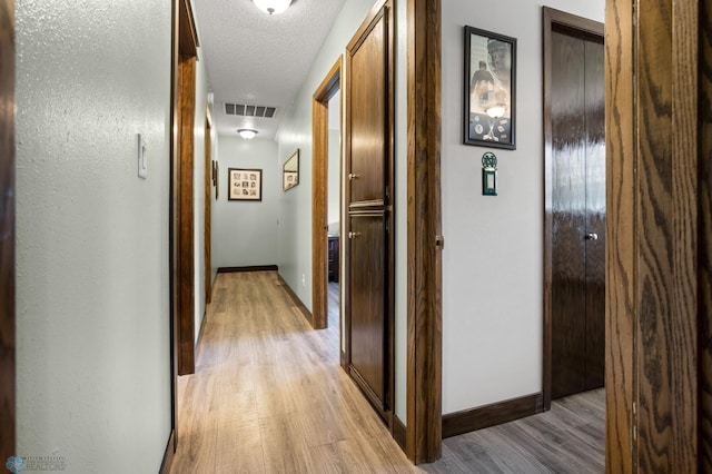 21 35th Ave NE, Fargo, ND 58102 - hall with light wood finished floors, a textured ceiling, and attic access