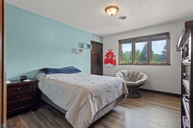 21 35th Ave NE, Fargo, ND 58102 - bedroom featuring dark wood finished floors and a textured ceiling