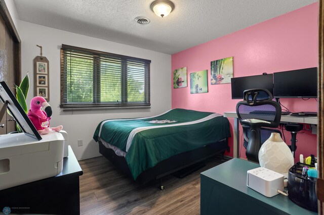 21 35th Ave NE, Fargo, ND 58102 - bedroom with wood finished floors and a textured ceiling